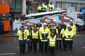 PLA staff pose beside the float