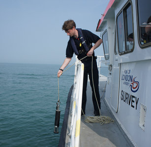 Surveyor Alex Mortley lowers the calibration equipment ready for the survey